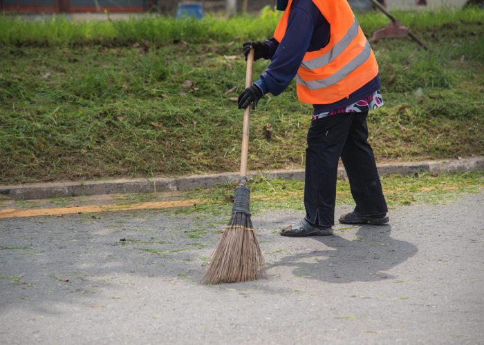 Road sweeper worker cleaning city street with broom tool in Thailand